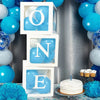White box containing blue balloons spelling out ONE to celebrate a first birthday or baby shower