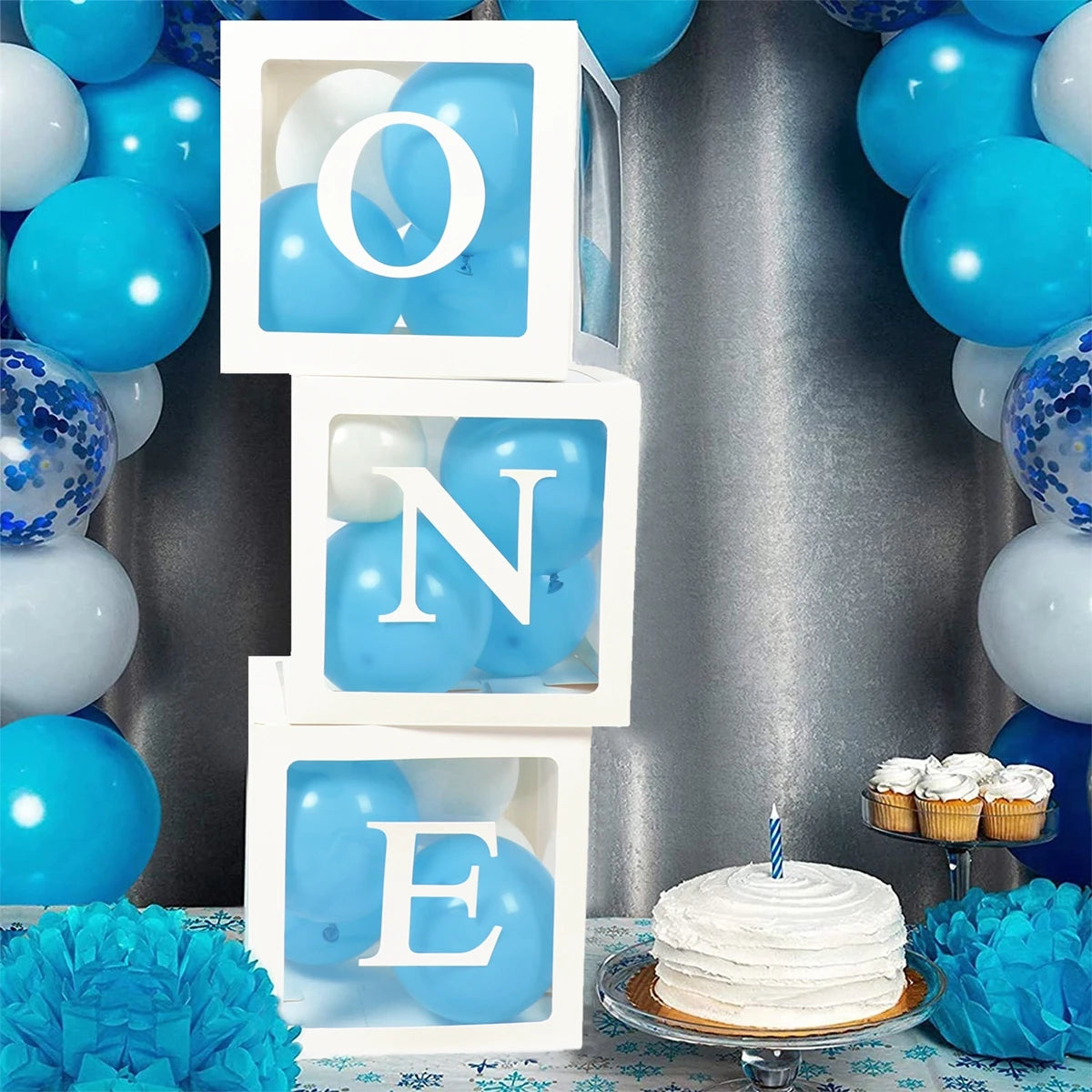 White box containing blue balloons spelling out ONE to celebrate a first birthday or baby shower