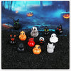 A collection of twelve mini resin Halloween duck figurines in various colors and styles displayed on a dark surface with glow