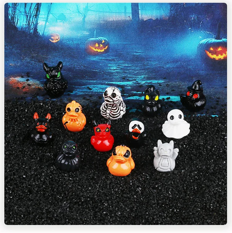 A collection of twelve mini resin Halloween duck figurines in various colors and styles displayed on a dark surface with glow