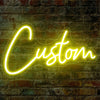 A bright yellow neon sign spelling the word Custom is displayed on a textured brick wall.