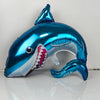 A blue shark foil balloon shaped like an ocean creature, used as a party decoration.