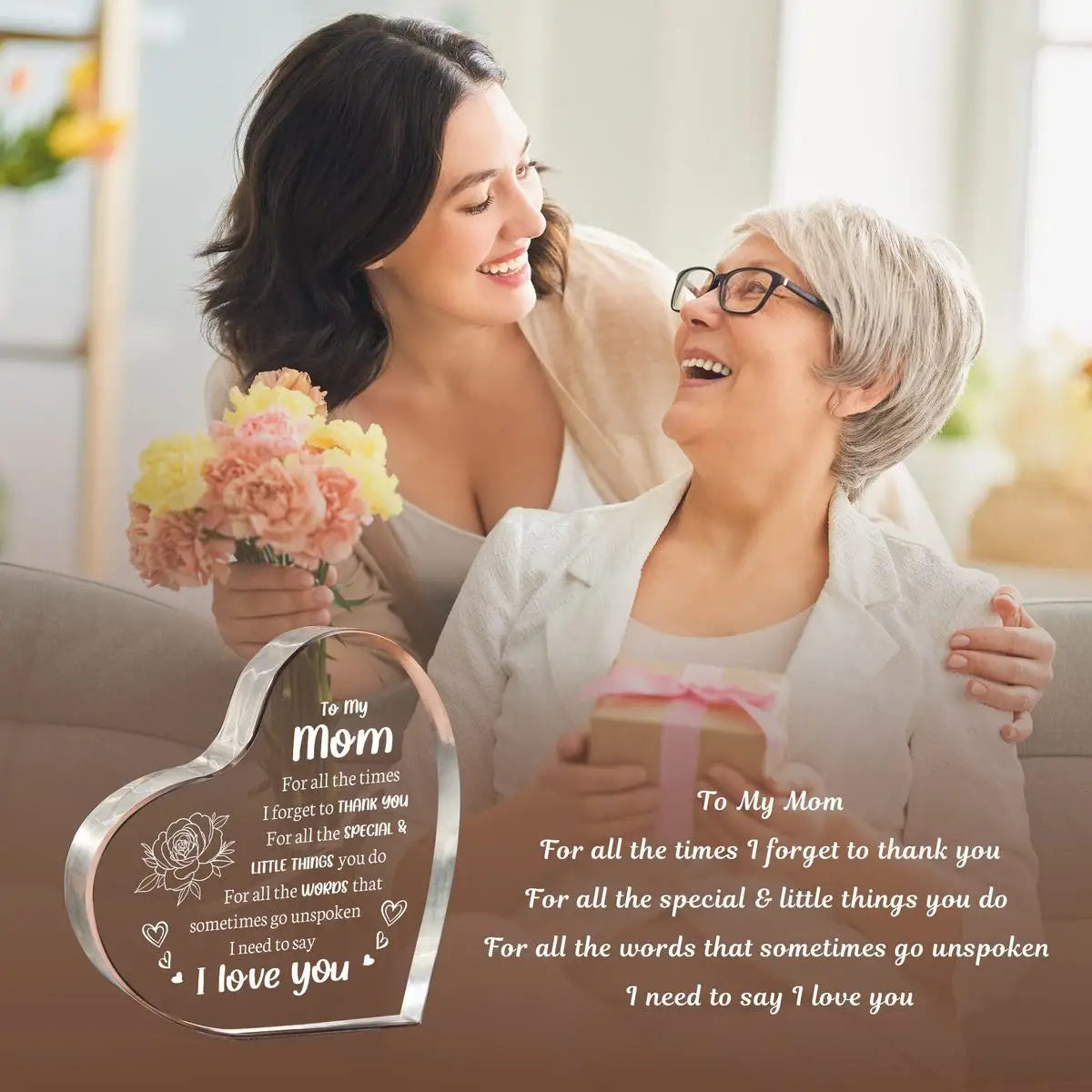A woman is smiling while holding an acrylic heart pendant engraved with 'I love you' for her mom.