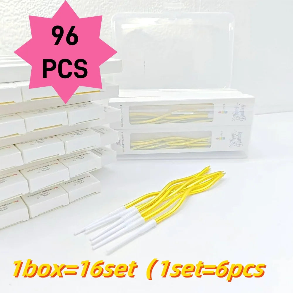 A box containing 96 pieces of long thin yellow spiral birthday candles for celebrations.