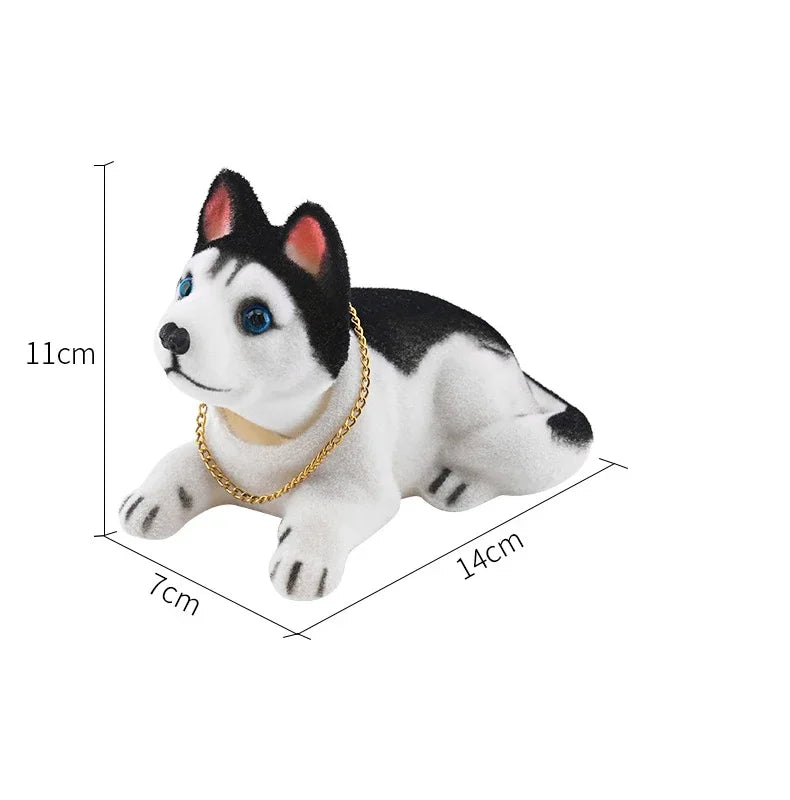 A white and black dog ornament figure with blue eyes and black ears, shown in a side profile.
