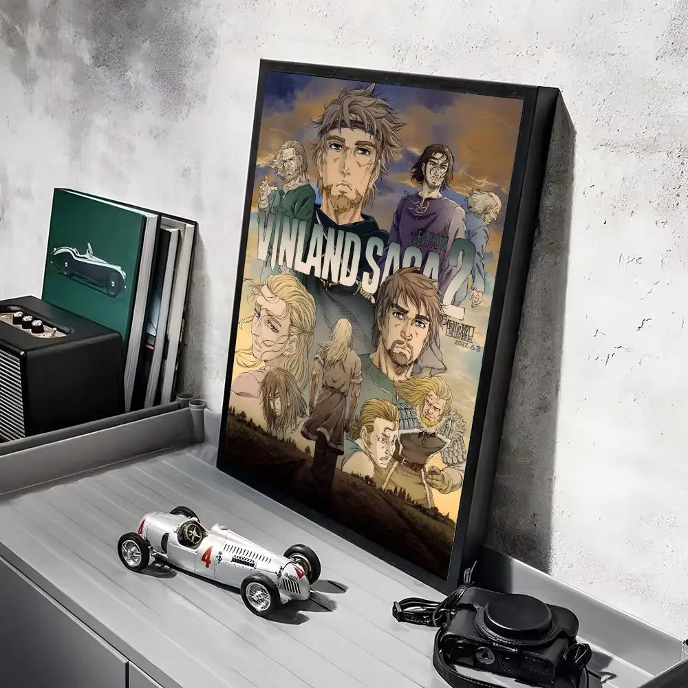 A framed poster of the Vinland Saga anime featuring characters in a dramatic scene.