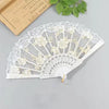 White lace folding fan decorated with delicate floral patterns and used for weddings or parties.