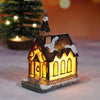 A festive Christmas house night light shaped like a small building with warm LED glow and snow accents.