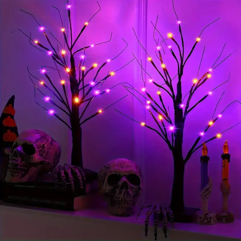 A glowing Halloween birch tree lamp featuring multiple LED lights and skull decorations.