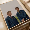 A movie poster featuring a man in a dark blue jacket and tie, displayed in a wooden frame.