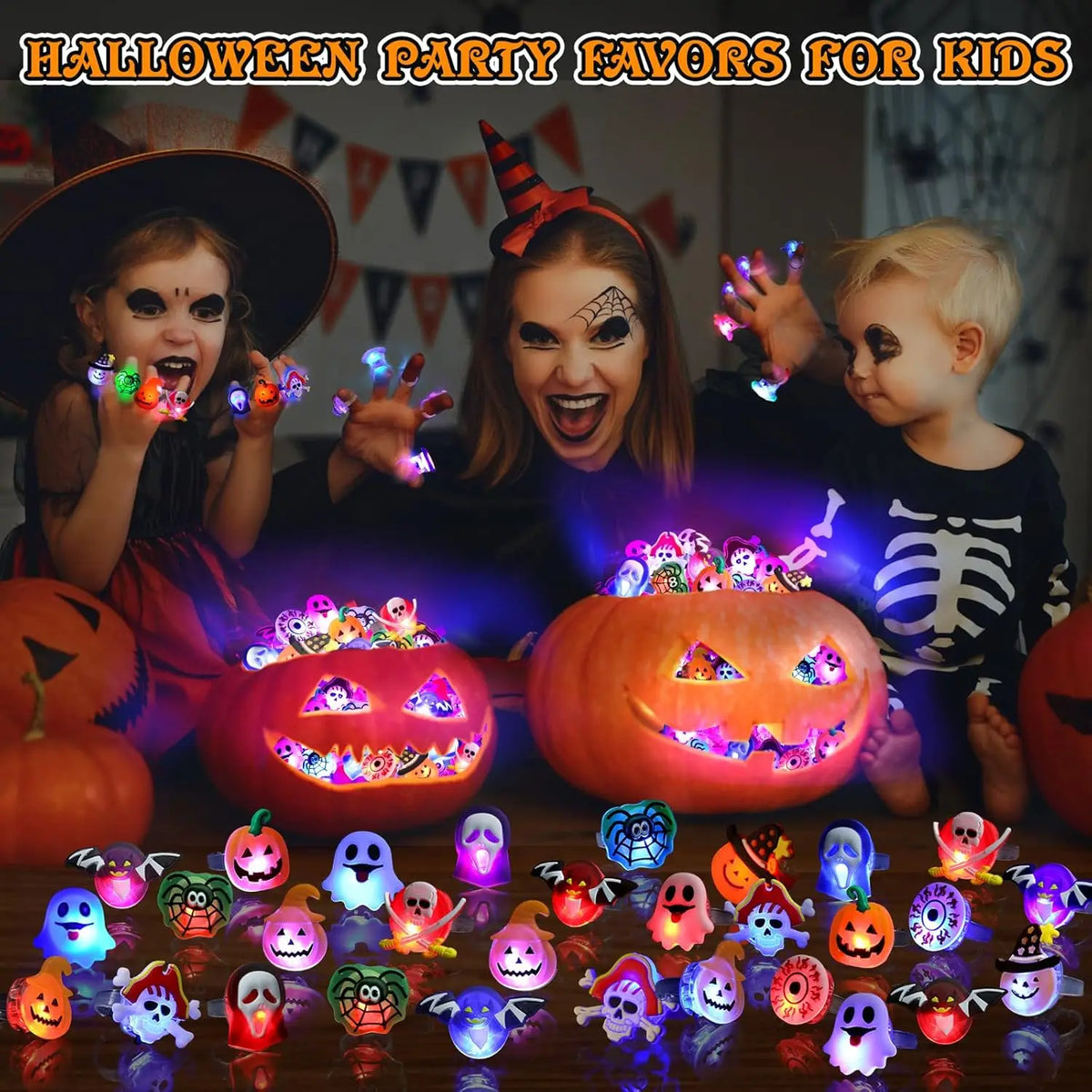 A collection of Halloween LED glow rings featuring pumpkin, ghost, and spider designs displayed on a dark surface.