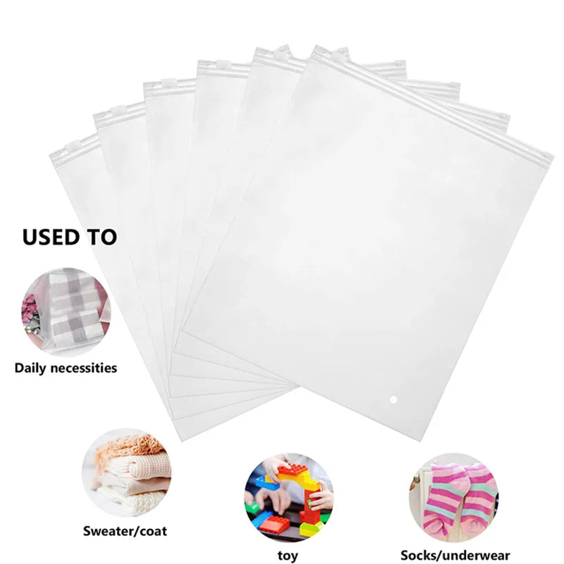 A stack of clear plastic storage bags used for organizing daily necessities like sweaters, coats, toys, and socks.