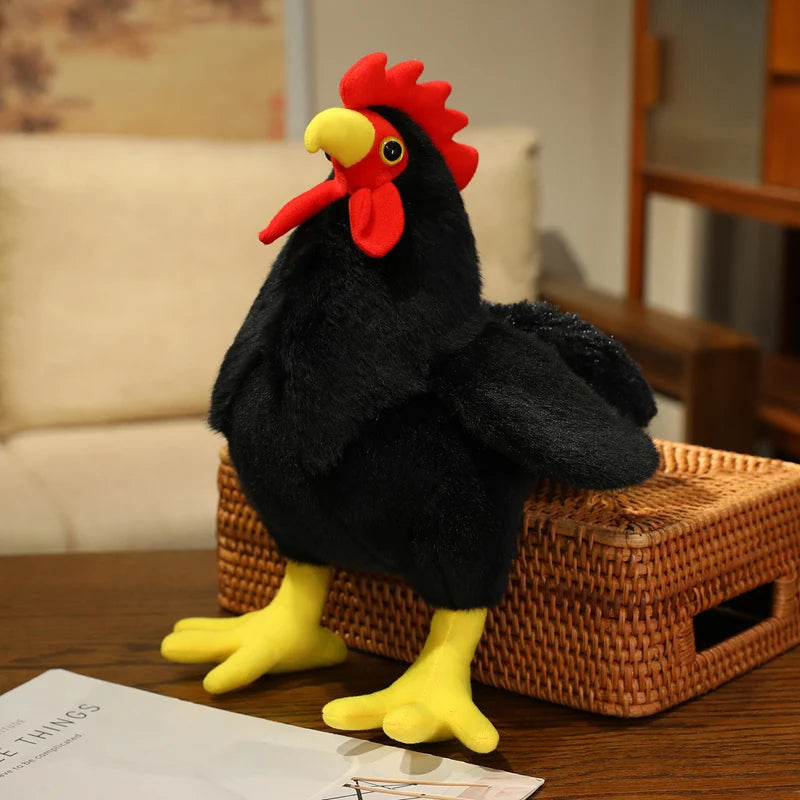A black and yellow plush rooster stuffed animal toy sitting on a wooden surface.