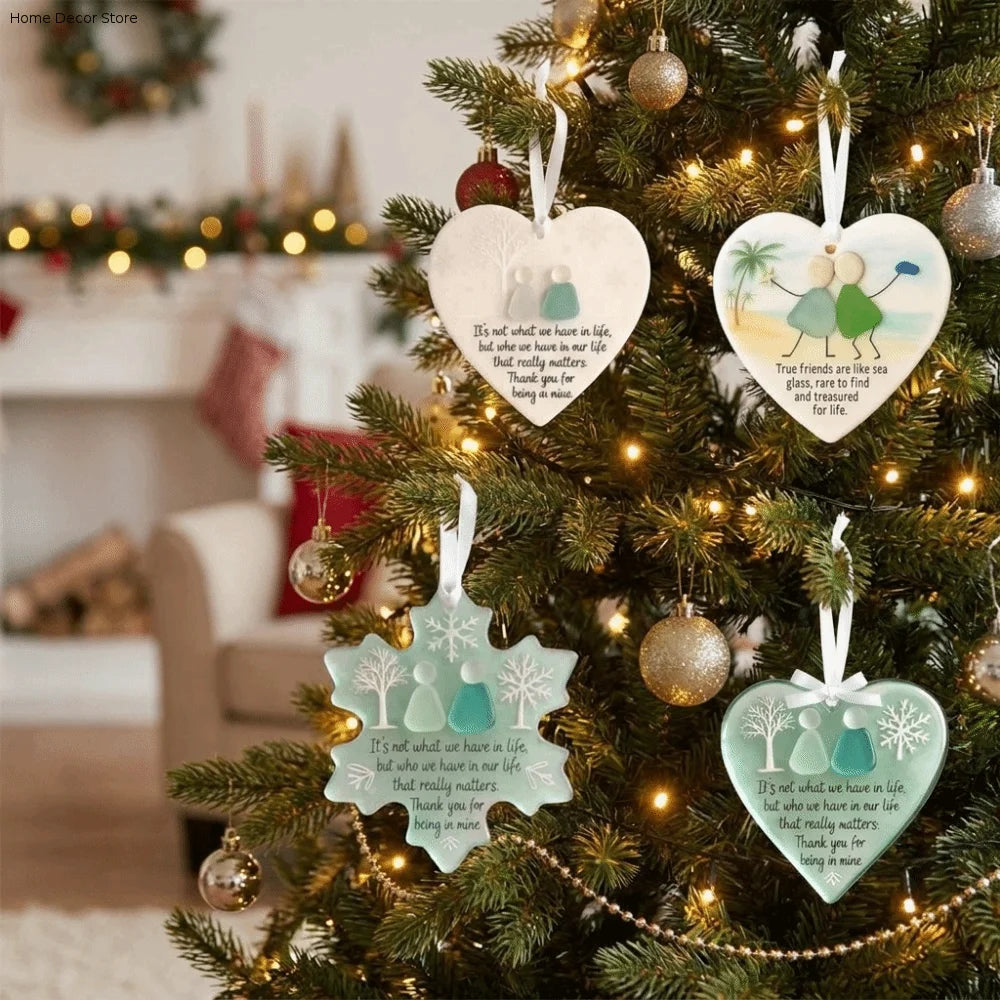 Handcrafted acrylic snowflake ornament hanging on a Christmas tree.