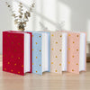 A set of ten elegant gold foil heart photo albums in red, blue, peach, and white, displayed on a wooden surface.