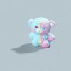 A small, soft blue and pink resin figurine of a bear with a wounded appearance.