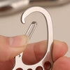 A hand holds a durable stainless steel keychain with a multi-loop design, showing the curved ring and a separate bar.
