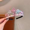 A set of three sparkling pink and iridescent pearl headbands displayed on a hand.