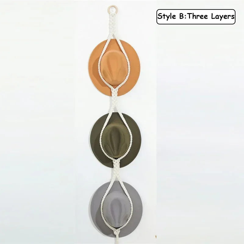 Three layers of macrame hat organizers with wooden dowels hanging vertically