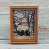 A framed painting depicting a black cat sitting in front of bare trees and a building.