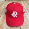 A red baseball cap embroidered with a white star and the letter R on the front.