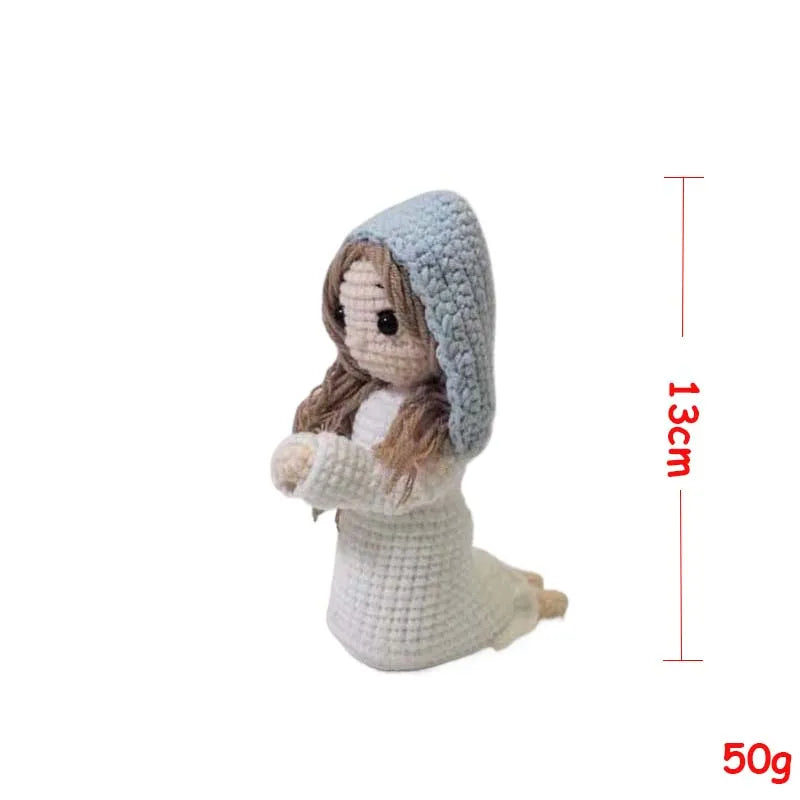Handcrafted Virgin Mary crochet doll with a light blue hooded garment and brown hair