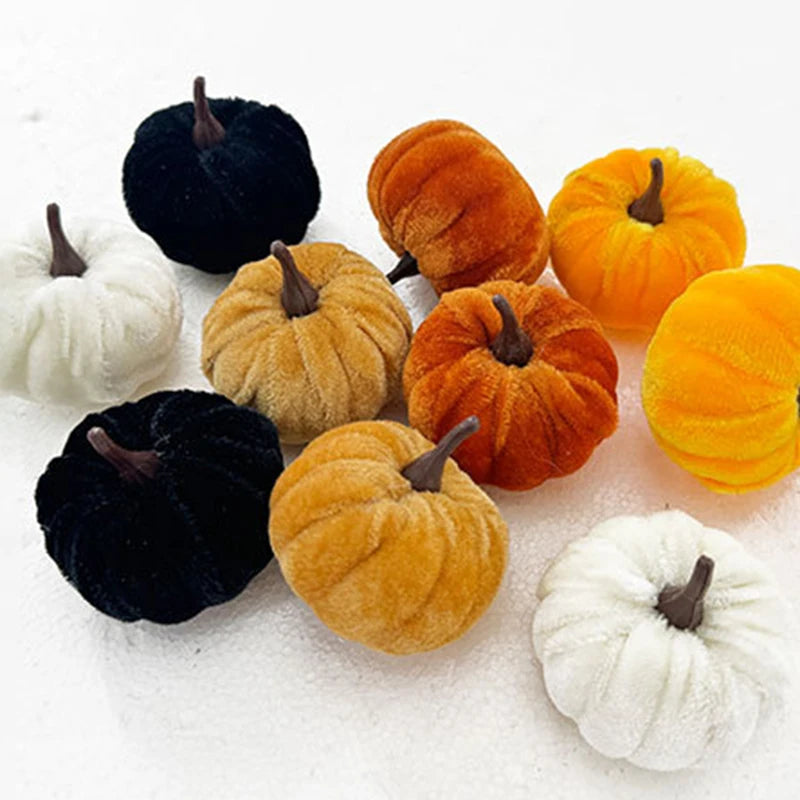 A set of five foam pumpkins in various colors including black, orange, yellow, and white.