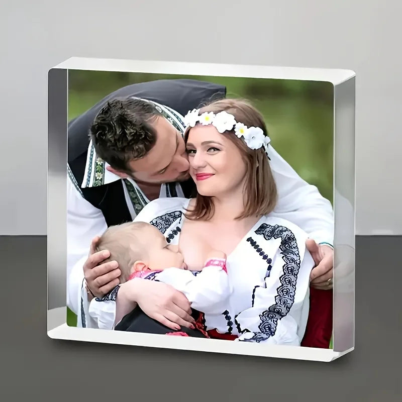 A framed photo of a mother holding her baby, featuring a floral crown on the mother's hair.