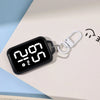 A black LED keychain pocket watch with a digital display showing 2:09 PM on a white surface.
