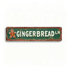 A rectangular, distressed green metal tin sign with the text GINGERBREAD in white lettering and a gingerbread man graphic.