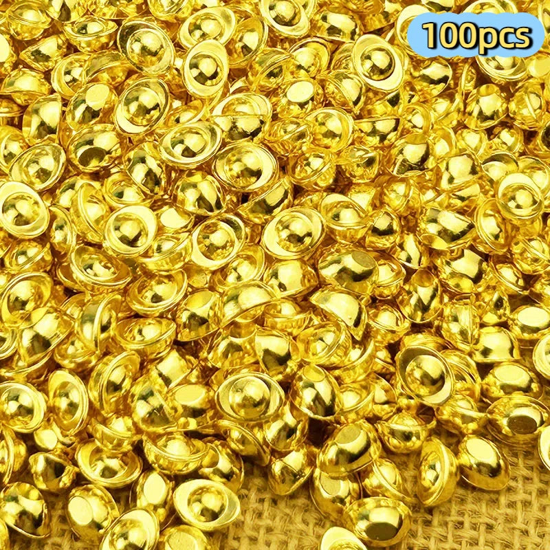 A pile of shiny gold metal prosperity decorations set.