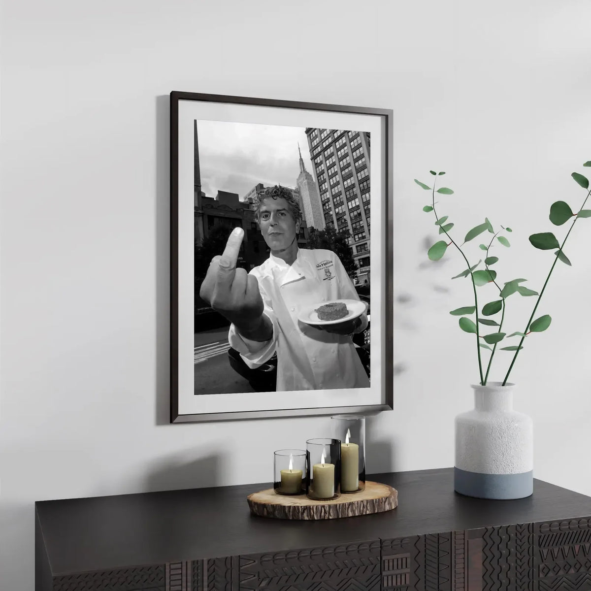 Framed black and white photograph of Anthony Bourdain making a peace sign