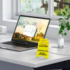 A yellow caution sign for overstimulated days rests on a desk in front of a laptop.
