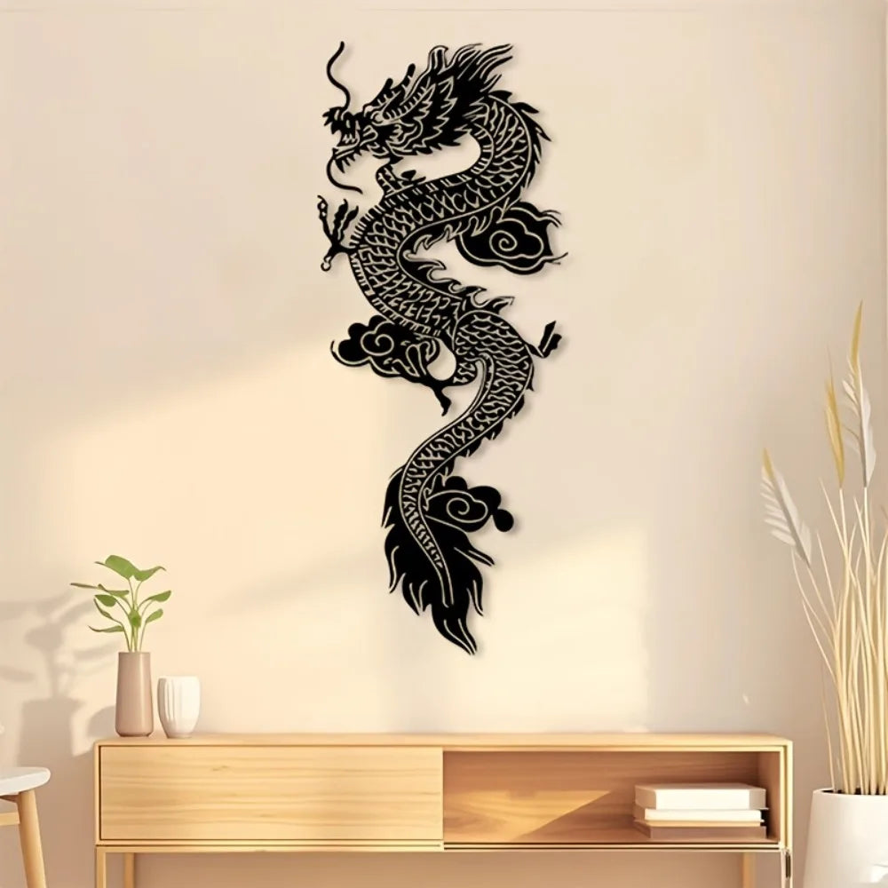 Black silhouette of a dragon wall art mounted on a light beige wall above a wooden shelf.