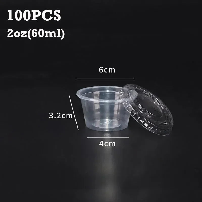 A set of 100 disposable clear plastic sauce cups with lids shown next to a measurement scale.