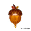 A golden foil balloon shaped like a pumpkin with leaves on top