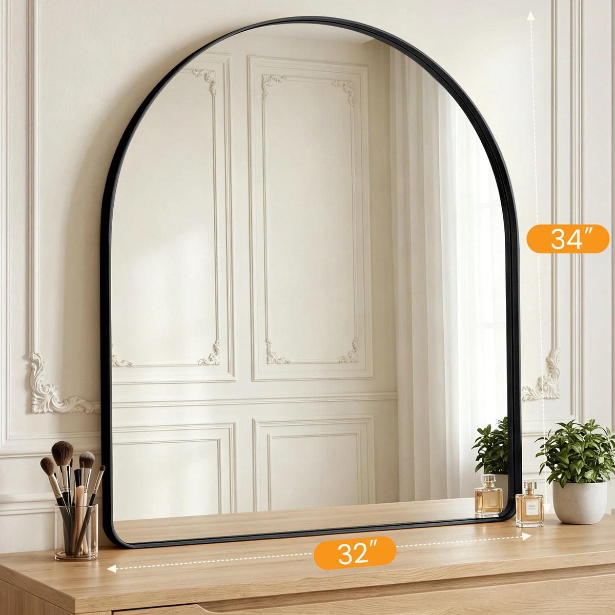 An arched full-length wall mirror with a matte black frame reflecting a room interior.