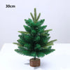 A small, green artificial pine tree displayed on a wooden base.