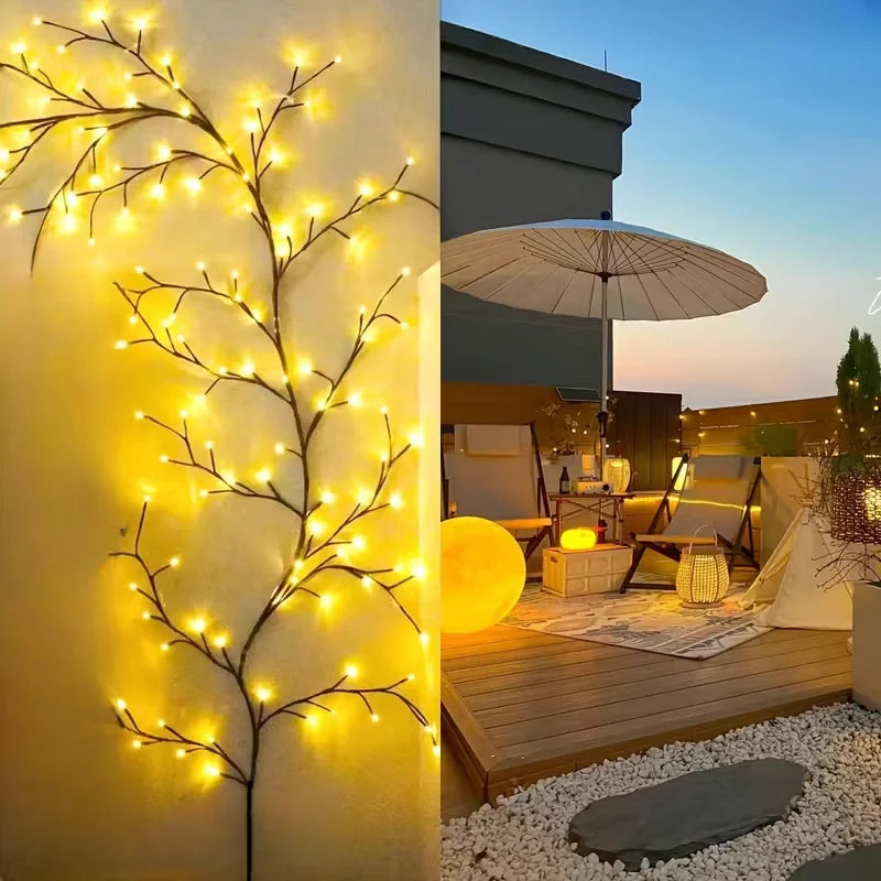 A close-up of a vertical wall decorated with glowing yellow LED willow vine lights in an outdoor setting.