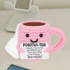 Pink handmade crochet tea cup ornament with a motivational message inside