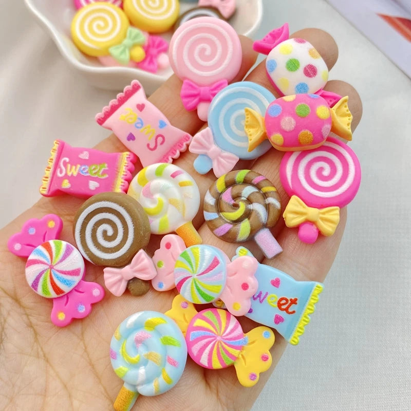 A collection of 20 colorful resin candy charms including lollipops, swirls, and bows for scrapbooking and jewelry making