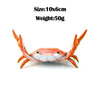 An orange crab-shaped desk organizer with a pen and phone holder.
