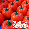 A close-up of several bright orange bell peppers used as squishy crunchy stress relief blocks.