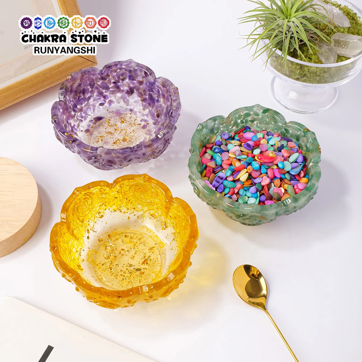 A set of natural crystal lotus bowls in purple and yellow colors for meditation and home decor.