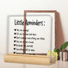 A framed acrylic desk plaque with a motivational sign listing positive affirmations like You are enough and Be kinder to your