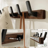 A walnut wood coat rack with eight hooks and a storage shelf mounted on a wall.