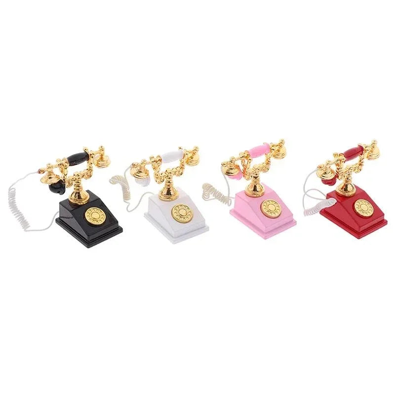 A set of vintage rotary desk phone miniature decor in black, gold, and pink colors.