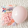 A clear plastic bag containing ten pastel pink latex balloons for party decorations