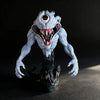 A highly detailed white and gray figurine of a monstrous, snarling creature with glowing red eyes and black tendrils.