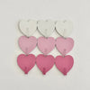 A set of six heart-shaped adhesive hooks in white and pink for use as no-drill key hooks.